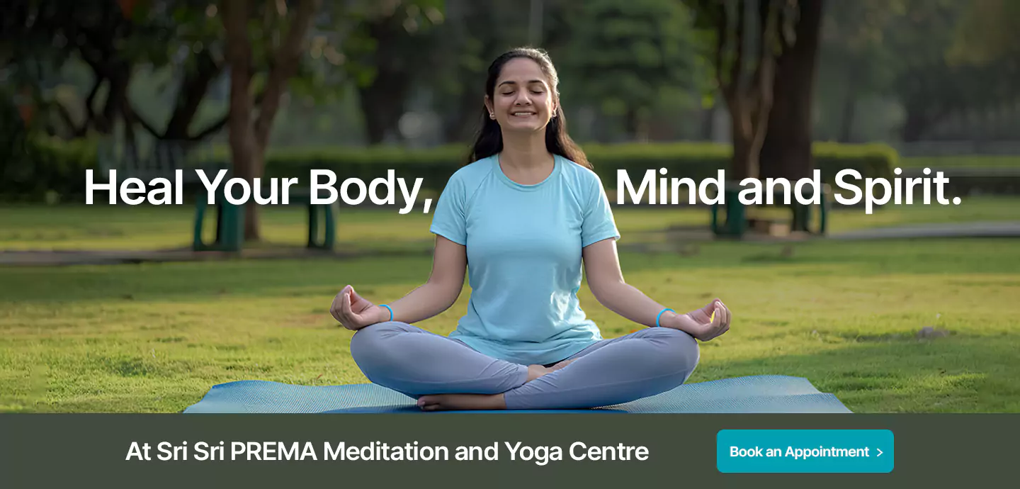 Woman meditating in lotus position at Sri Sri PREMA Yoga Centre. Heal body, mind, and spirit.